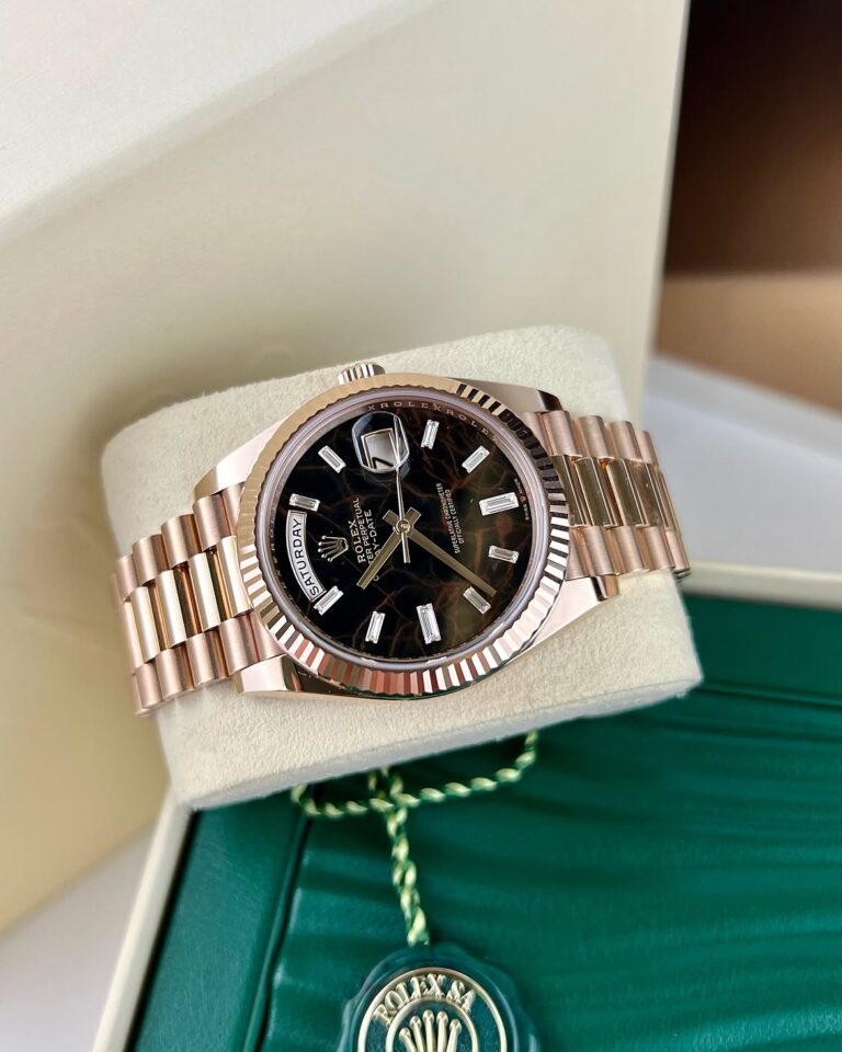 The 228235 Rose Gold Day-Date 40 Eisenkiesel Diamond Baguette Dial is a timepiece that embodies
